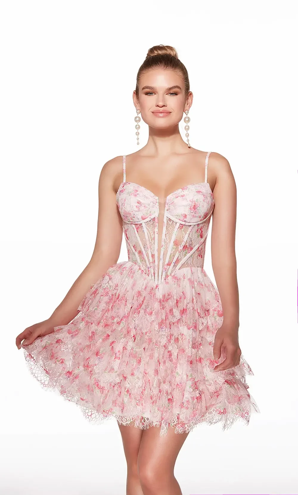 A woman in a pink floral dress with a fitted bodice and a flared skirt, smiling and posing.