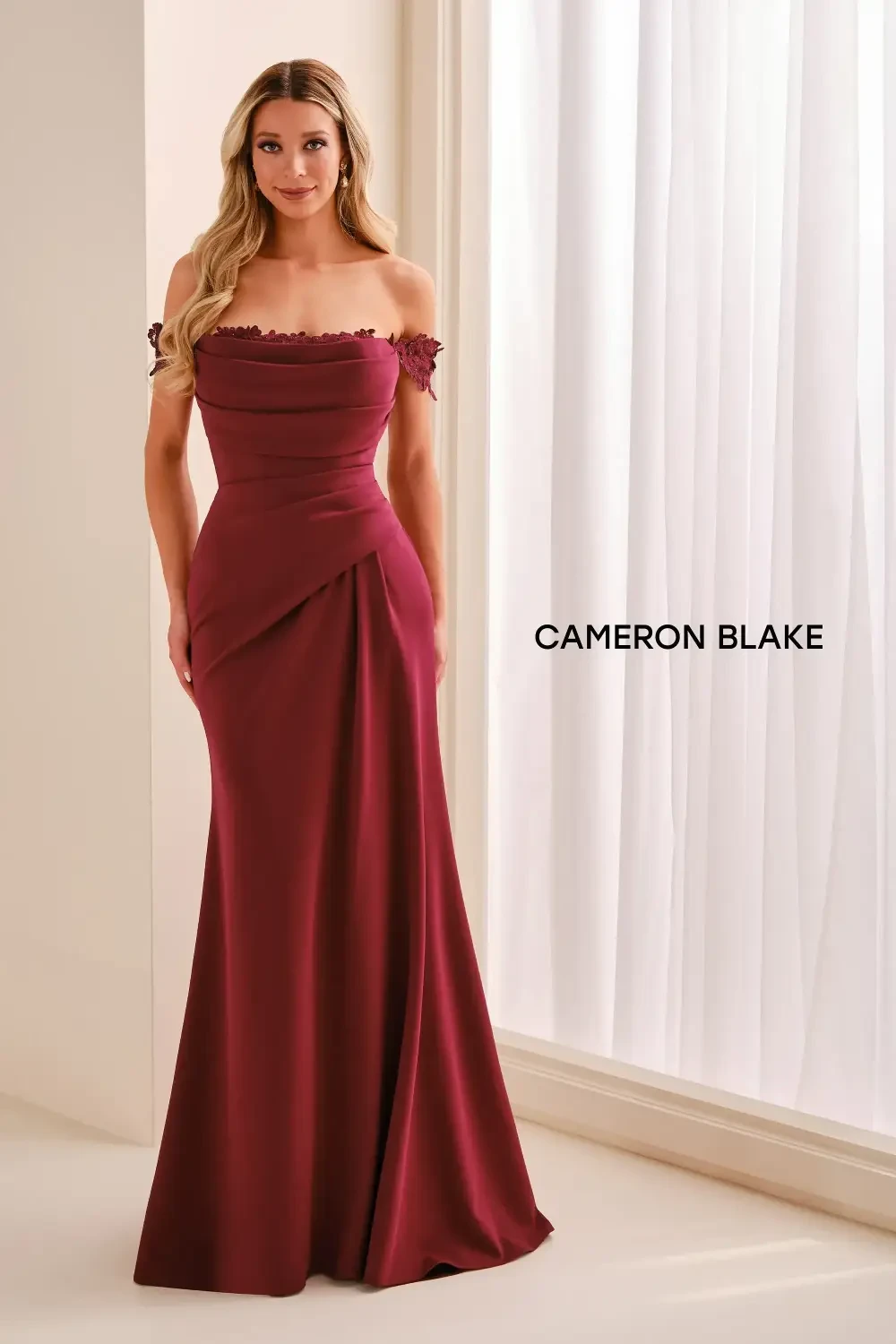 model is wearing a red mother of the bride dress
